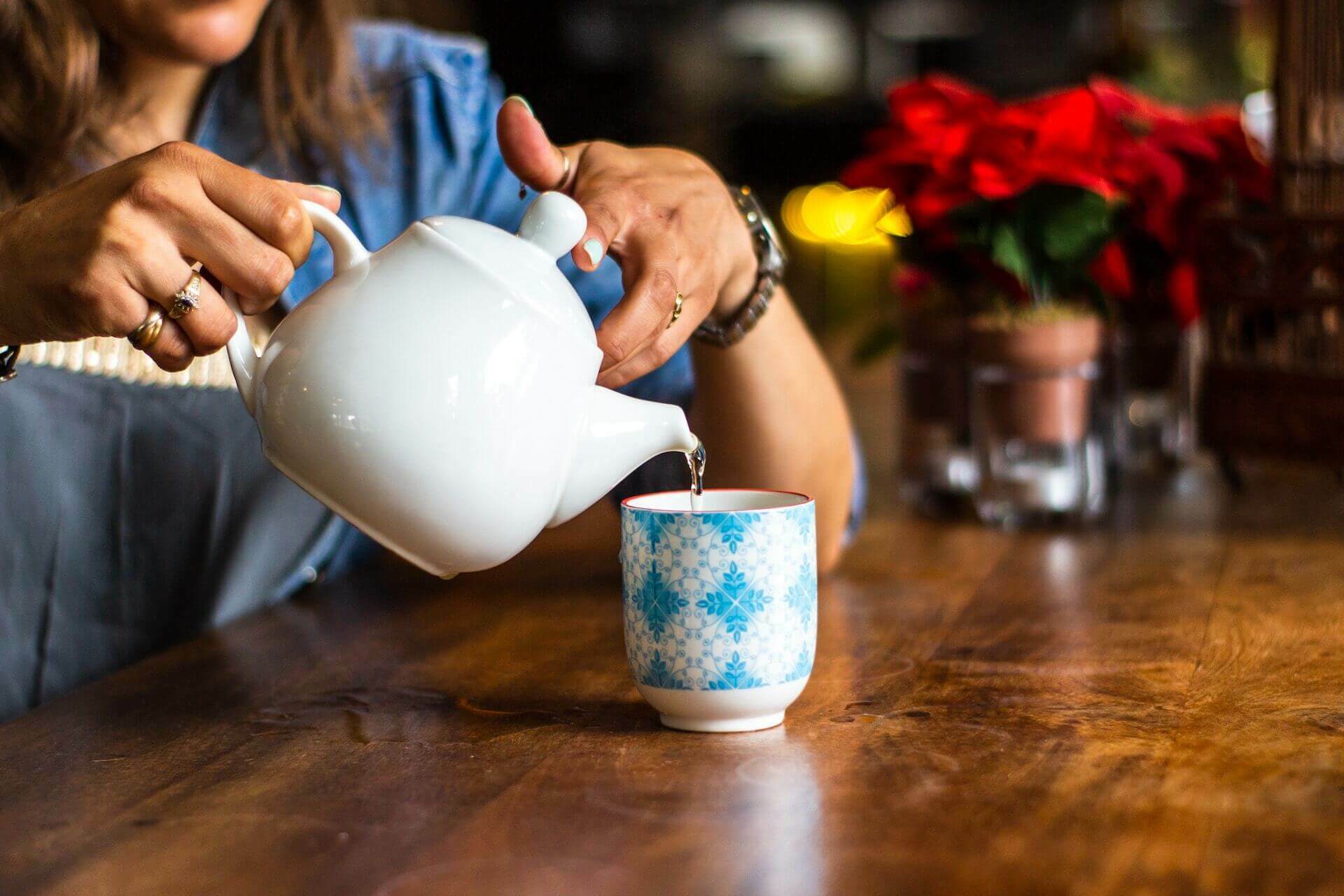 Person pouring a cup of tea