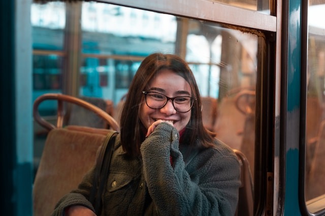 Young person on bus smiling