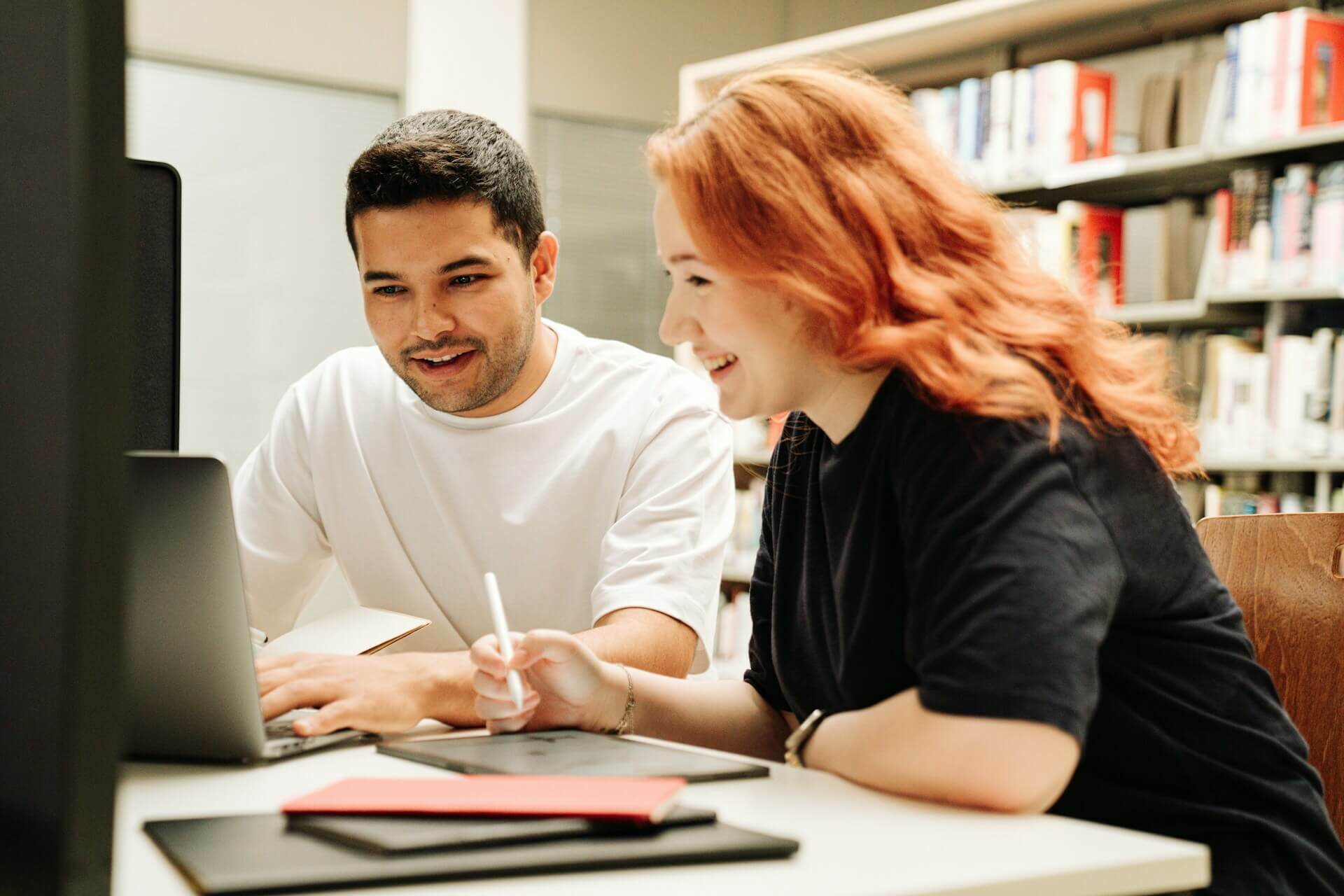 Trainer helping student in library