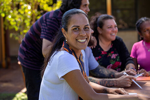 Aboriginal woman smiling during community meeting