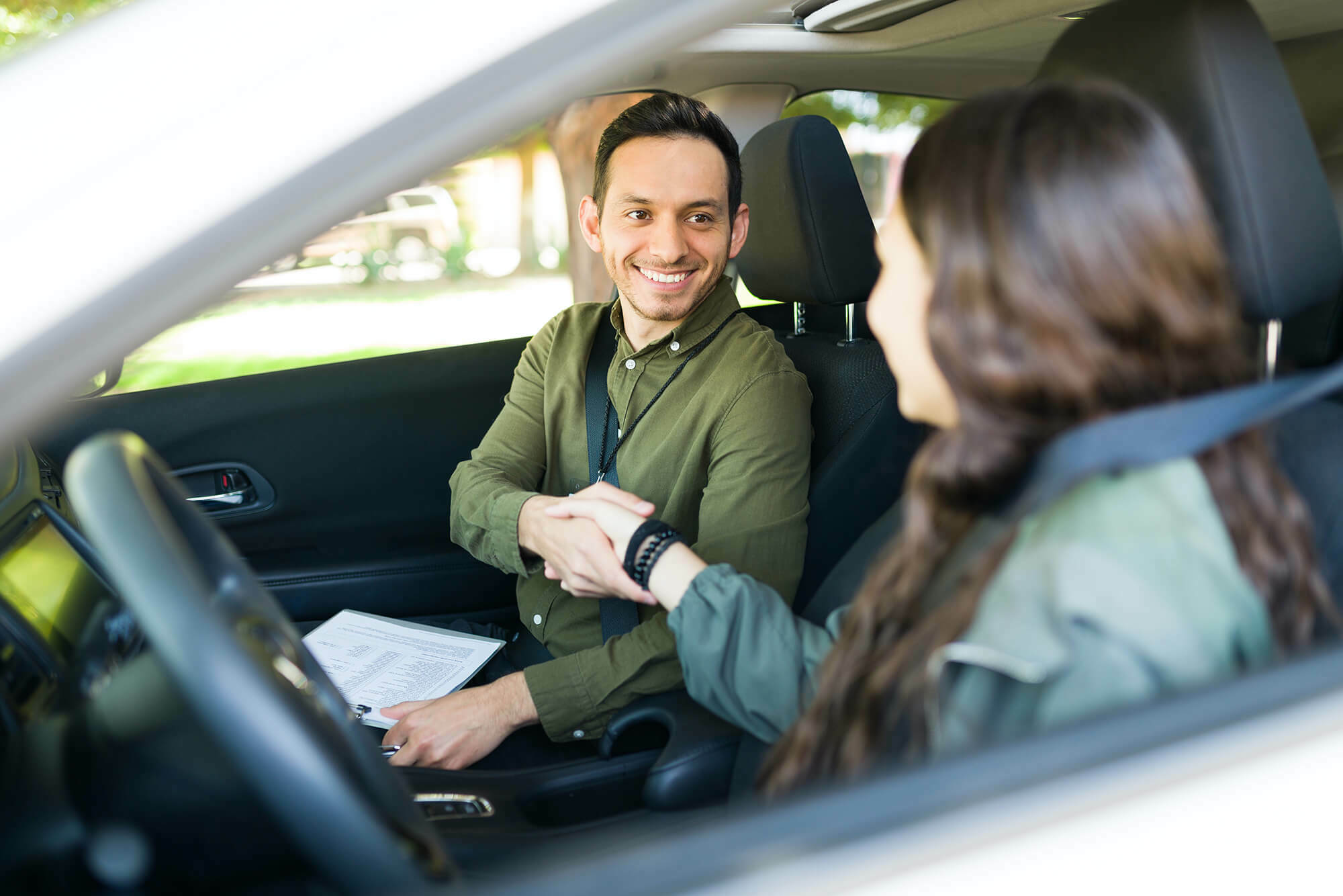 Driving instructor shaking hands with student